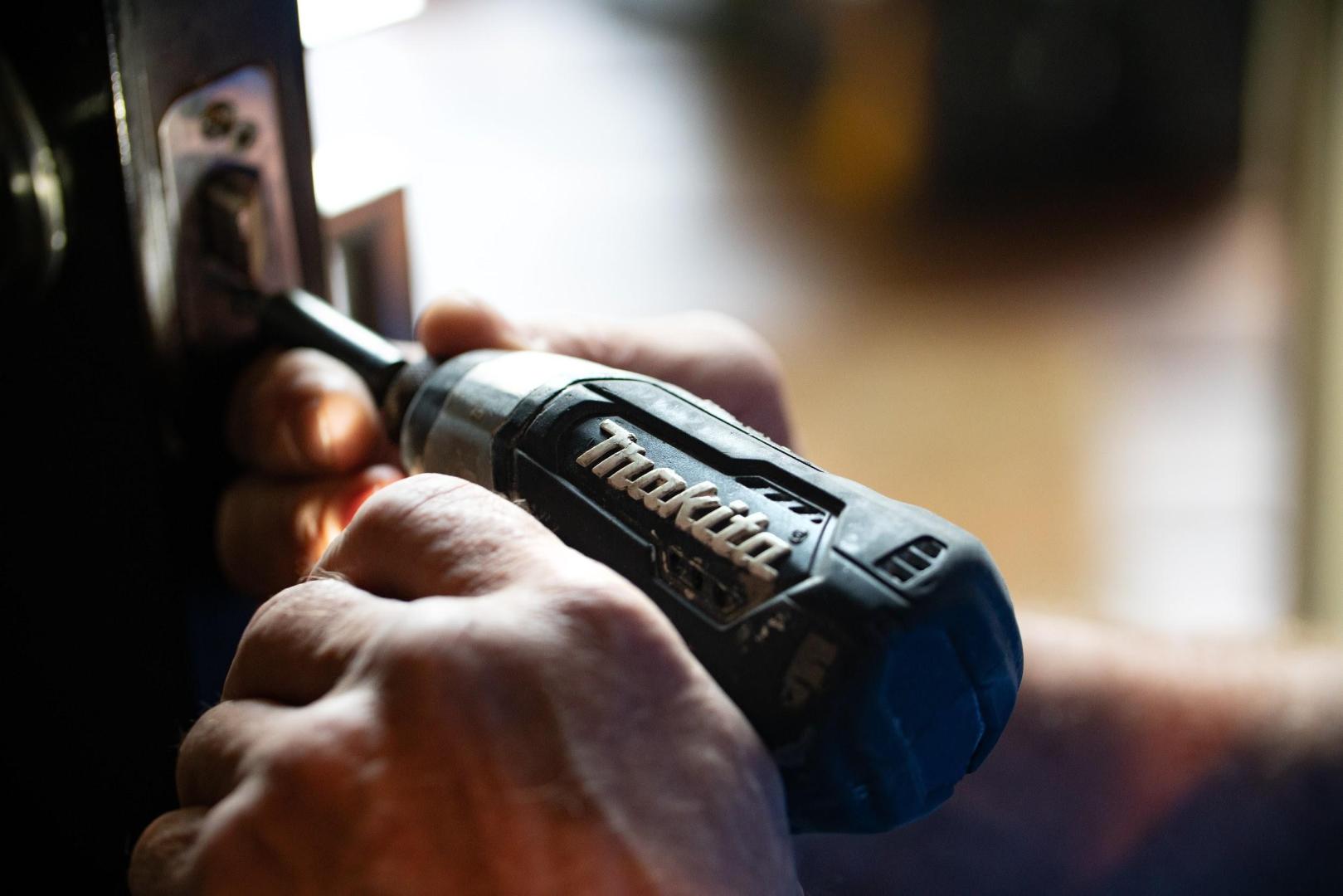 Somebody using a power drill in a repair project