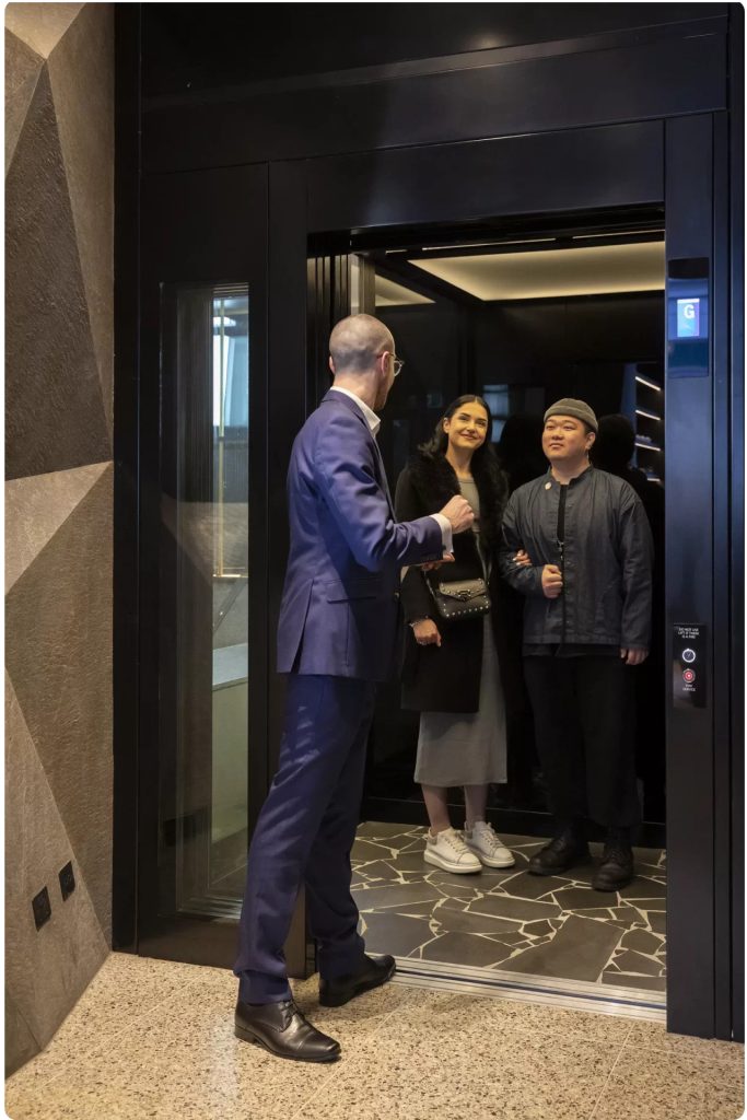 Men and Women Discussing on the Elevator